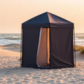 Pop-up changing shower tent on sandy beach at sunset