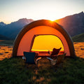Family inflatable tunnel tent in alpine meadow at sunset
