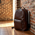 PU leather laptop backpack on a wooden desk in modern office