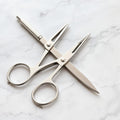 Stainless steel nail scissors manicure set on marble surface
