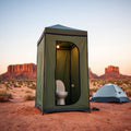 Privacy shower toilet tent at desert campsite at golden hour