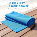 Quick-drying microfiber travel towel folded with mesh pouch on wooden deck